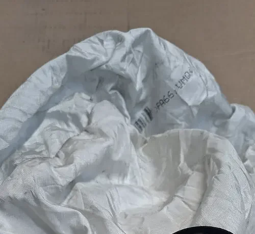 A deployed airbag, a crumpled grey and white bag